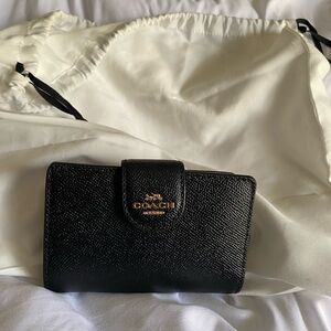 Small black wallet made by coach zipper for coins